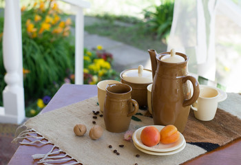 breakfast in the open air, on the veranda in the garden. Coffee set and apricot, walnut