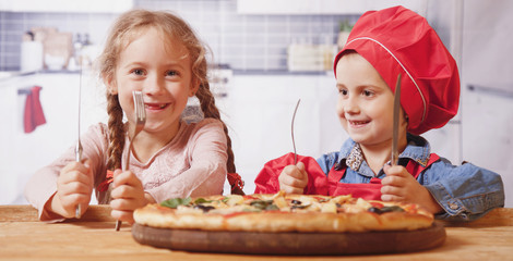 We love pizza! Two funny child girls friends want to eat pizza.