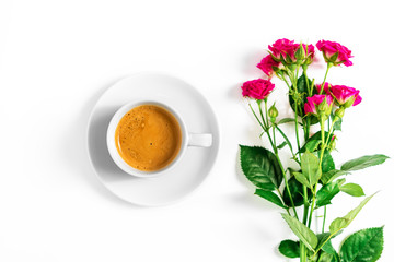 pink roses with a cup of coffee isolated on a white background