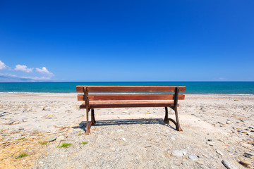 Obraz premium Empty bench at Maleme beach on Crete, Greece