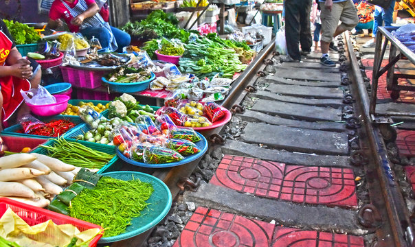 Selling food on the Maeklong Railway market in Thailand