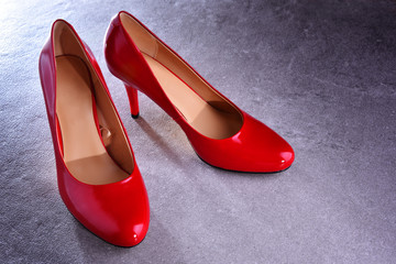 Composition with a pair of red high heel shoes