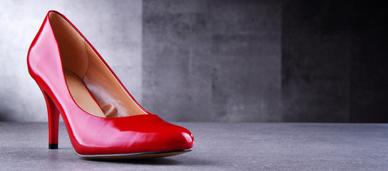 Composition with a pair of red high heel shoes