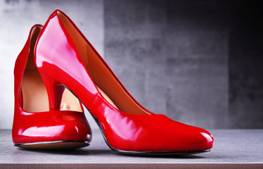 Composition with a pair of red high heel shoes