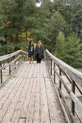  Mature couple walking on the wooden bridge. Casual wear. True love.