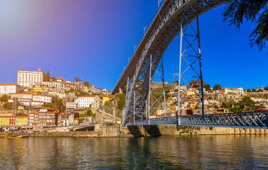 Fototapeta na wymiar Porto panoramic aerial view of Dom Luis Bridge and houses with red roof tiles in a beautiful summer day. Porto, Portugal
