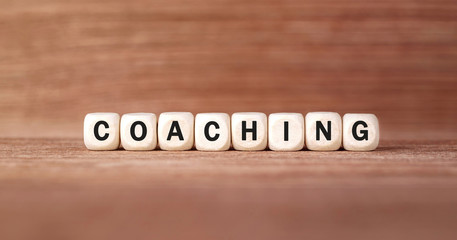 Word COACHING made with wood building blocks