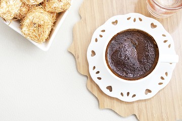 Turkish coffee with Shredded dough baked in syrup topped with crushed nuts Turkish delight and hearth shape cup top view