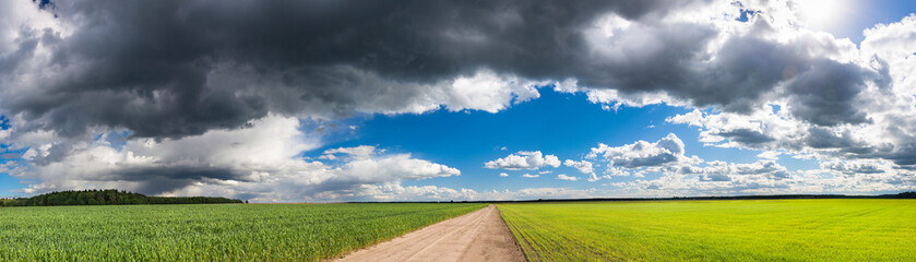 rural landscape panorama with fields, road and sky