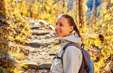 Tourist hiking in aspen grove at autumn