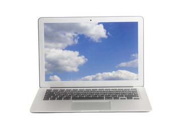 Laptop with blue sky and white clouds on screen
