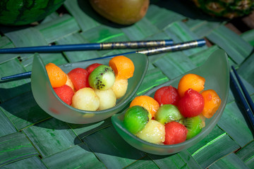 deux coupes remplies de billes de fruits de toutes les couleurs , melon, pastèque, kiwi