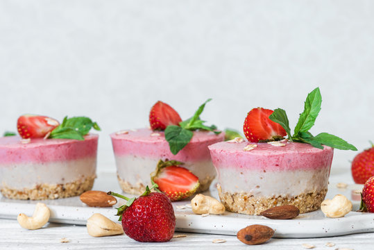 homemade raw strawberry cakes with fresh berries, mint, nuts. healthy vegan food