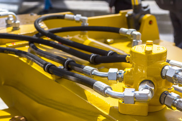 Close up of pipe system of hydraulic valves in agricultural machinery