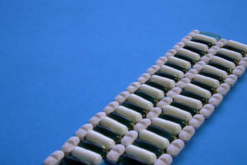 Naklejka premium tablets and capsules on a blue background