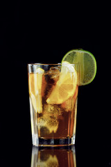 Cold green tea with lemon on a black background