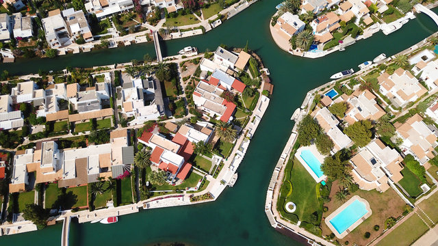 Aerial drone bird's eye view photo of famous seaside resort of Porto Hydra built on canals with boats docked resembling Venice or Miami, Peloponnese, Greece