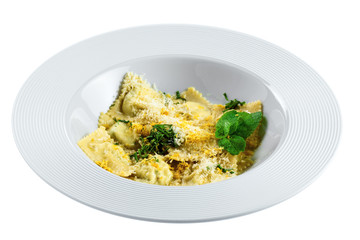 Ravioli filled with ricotta, mint and grated lemon rind isolated on white background. Classic Italian cuisine pasta meal in a soup plate.