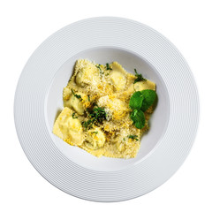 Delicious Italian ravioli with ricotta, mint and grated lemon rind served in a soup plate. Classic Italian cuisine food isolated on white. Top view.