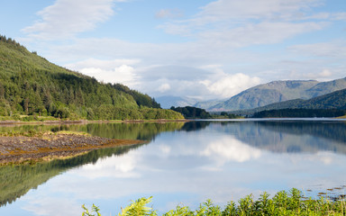 Fototapeta premium Loch Leven. The view across Loch Leven from Ballachulish towards Ballachulish Bridge in the Scottish highlands. Loch Leven is a sea loch on the west coast of Scotland.
