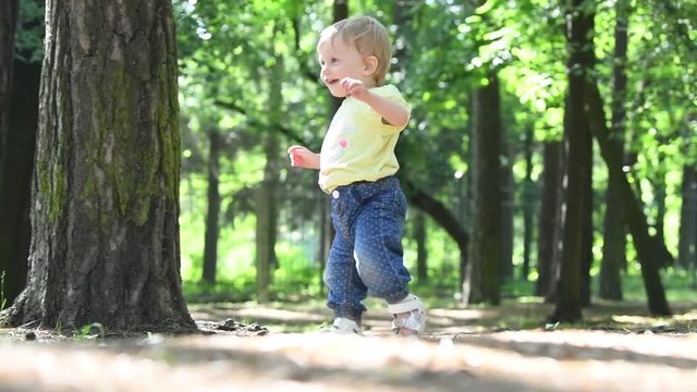 first steps. female baby toddler learns to walk