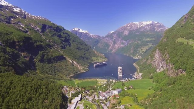 Geiranger fjord area, Norway. Aerial view at summer time. Fairytale landscape with its majestic, snow-covered mountain tops. Fantastic view of one of most beautiful tourist destinations in the world