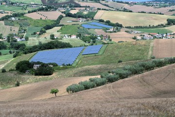 Fototapeta na wymiar hill,photovoltaic panels,countryside,field,landscape,view,crops,cereals