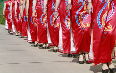 Women in cheongsam are walking