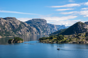 Obraz na płótnie Canvas Fantastic nature landscape view of the fjord, mountains and sailing vessel. Location: Lysefjorden, Scandinavian Mountains, Norway, Europe. Artistic picture. Beauty world.