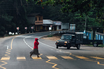 Woman crossing the street at a pedestrian crossing