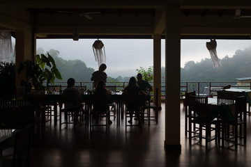  View of   terrace, silhouette people eat at the table