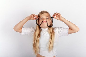 Funny teen girl showing a mustache from a black slime