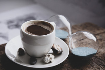 Image in retro style, dreaming of summer vacation, cup of coffee, seashells, sandglass