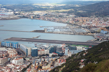 Aerial view on city and airport runway of Gibraltar and Spanish La Linea town on a background.