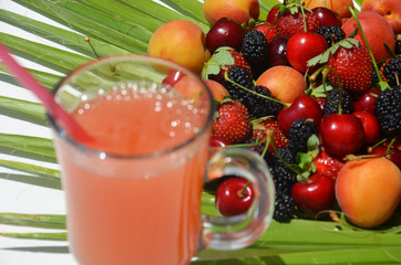 extremely close up glass of tasty tropical alcohol cocktail with berries or lemonade with beautiful decoration on a table in a restaurant with backgrounds of bright colored lights. soft focus.