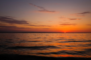 Fototapeta na wymiar Beautiful fiery sunset sky on the beach. Composition of nature