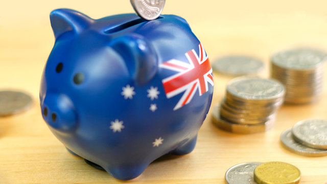 Australian piggy bank and coins savings concept, closeup macro shallow DOF.