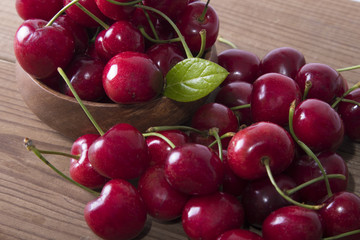 red cherries on rustic wood