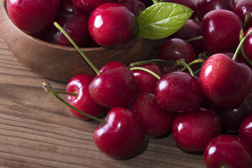 red cherries on rustic wood