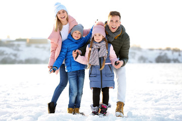 Portrait of happy family outdoors on winter day