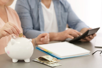 Mature couple thinking over pension payment at home, closeup