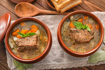 Crock pots with stewed meat on table