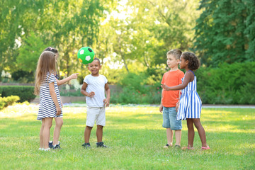 Fototapeta premium Cute little children playing with ball outdoors