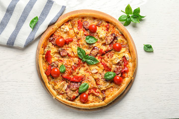 Delicious pizza with tomatoes and sausages on table, top view