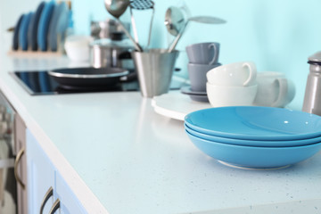 Fototapeta na wymiar Plates on table in modern kitchen