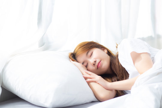 Portrait of beautiful asian young woman sleep lying in bed with head on pillow comfortable and happy with leisure, girl with relax  for health and lifestyle concept.