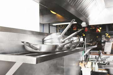 Cookware on shelf in restaurant kitchen © Africa Studio