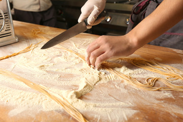 Male chef preparing pasta in restaurant kitchen