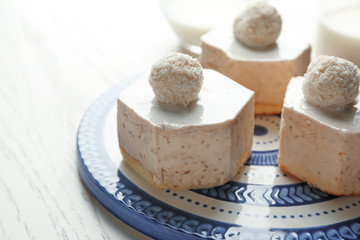 Plate with tasty souffle cakes on wooden table, closeup