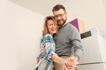 Lovely couple dancing together in kitchen